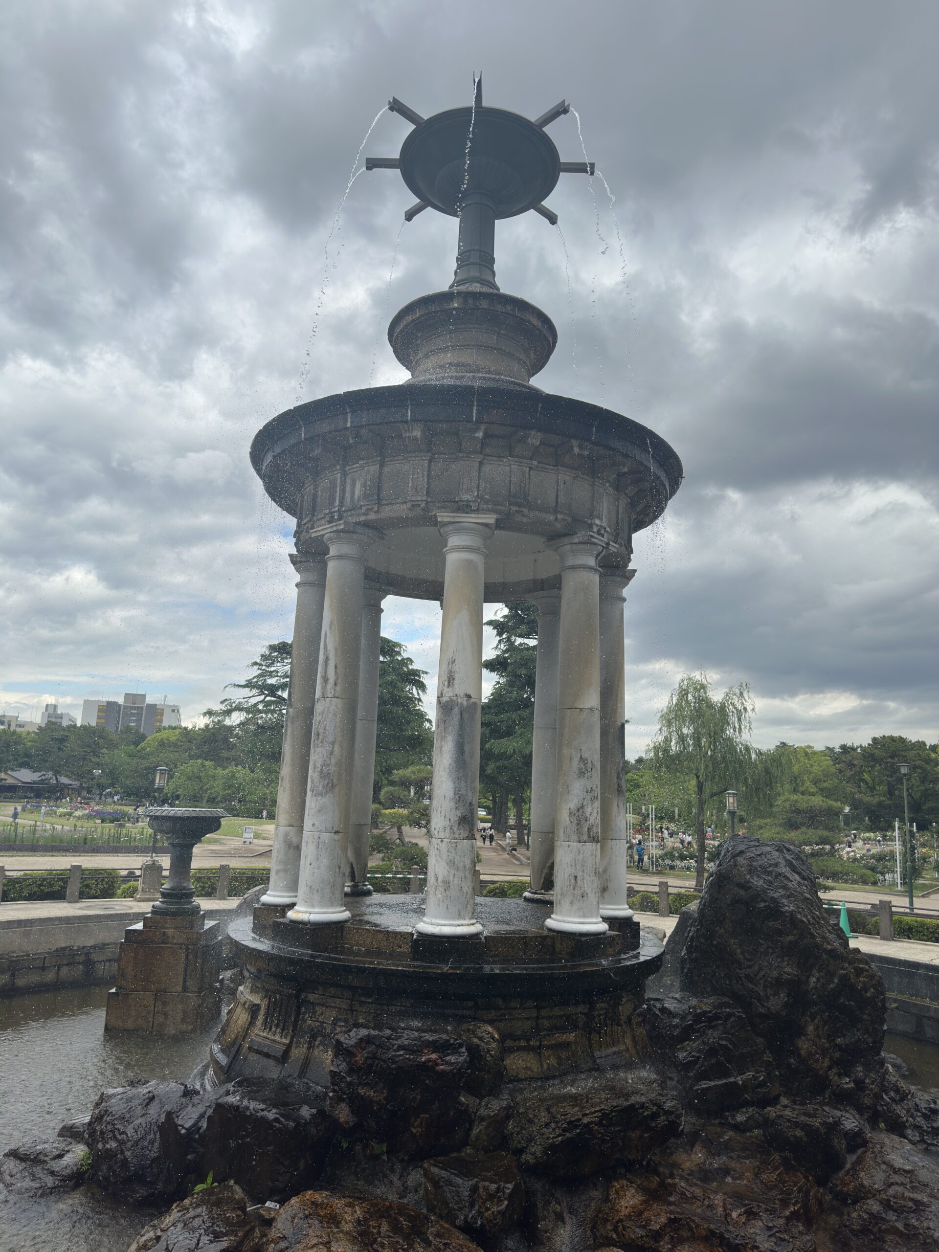 A tower with waterfalls in the park captured in daylight with the iPhone 14 Pro Max 48MP camera